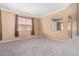 Cozy living room with carpeting, neutral walls, and a view to the dining area at 41800 W Chambers Ct, Maricopa, AZ 85138
