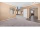 Expansive living room with high ceilings and neutral walls, seamlessly connecting to the dining area at 41800 W Chambers Ct, Maricopa, AZ 85138