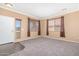 Inviting living room featuring plush carpeting, neutral walls, and window blinds for privacy at 41800 W Chambers Ct, Maricopa, AZ 85138