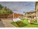Spacious backyard featuring a hammock, artificial turf, and covered patio at 44715 W Paitilla Ln, Maricopa, AZ 85139