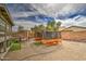 Backyard with gravel, raised garden beds, artificial turf, and shade at 44715 W Paitilla Ln, Maricopa, AZ 85139