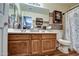 Bathroom featuring a double vanity with wood cabinets, and a shower-tub combo at 44715 W Paitilla Ln, Maricopa, AZ 85139
