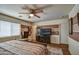 A bedroom featuring a ceiling fan, horizontal striped walls, and a dresser at 44715 W Paitilla Ln, Maricopa, AZ 85139