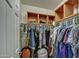 Walk-in closet with built-in shelves and hanging rods for storage at 44715 W Paitilla Ln, Maricopa, AZ 85139