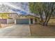 Inviting single-story home with a well-maintained front yard and a spacious driveway leading to a two-car garage at 44715 W Paitilla Ln, Maricopa, AZ 85139