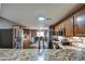 Eat-in kitchen features wood cabinets, stainless steel appliances, and a dining area at 44715 W Paitilla Ln, Maricopa, AZ 85139