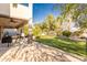 Expansive backyard with a covered patio, lush lawn, mature trees, and a lounge area, perfect for outdoor living at 549 W Sweet Shrub Ave, Queen Creek, AZ 85140