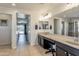 Bathroom with double sink vanity, large mirror, and separate toilet and shower area at 549 W Sweet Shrub Ave, Queen Creek, AZ 85140