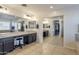 En Suite bathroom featuring double sinks, vanity, large mirror, and large walk-in closet at 549 W Sweet Shrub Ave, Queen Creek, AZ 85140
