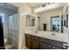 Bathroom with double sinks, vanity and shower/tub combo at 549 W Sweet Shrub Ave, Queen Creek, AZ 85140