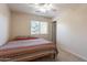 Neutral bedroom featuring a comfortable queen bed with a patterned comforter and a window letting in natural light at 549 W Sweet Shrub Ave, Queen Creek, AZ 85140