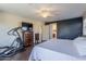 Primary bedroom featuring a ceiling fan, a television, and an ensuite bathroom at 549 W Sweet Shrub Ave, Queen Creek, AZ 85140