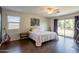 Spacious bedroom featuring a ceiling fan, guitar, and access to a private balcony at 549 W Sweet Shrub Ave, Queen Creek, AZ 85140