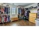 Large walk-in closet featuring ample hanging space, shelving, and natural light at 549 W Sweet Shrub Ave, Queen Creek, AZ 85140