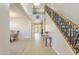 Bright foyer featuring decorative tile flooring, staircase with wrought iron railing, and natural light at 549 W Sweet Shrub Ave, Queen Creek, AZ 85140