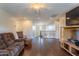 Open-concept living area with wood floors, comfortable seating, and staircase at 549 W Sweet Shrub Ave, Queen Creek, AZ 85140