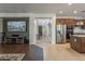 Open-concept living room featuring a modern kitchen, front entry, and hardwood flooring at 549 W Sweet Shrub Ave, Queen Creek, AZ 85140