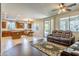 Spacious living room with kitchen and dining area, plus access to outdoor patio at 549 W Sweet Shrub Ave, Queen Creek, AZ 85140