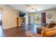 Comfortable living room with patio access, ceiling fan, and wood-look flooring at 549 W Sweet Shrub Ave, Queen Creek, AZ 85140