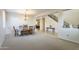 Spacious living room with plush carpeting, ample natural light, and view into the dining area at 549 W Sweet Shrub Ave, Queen Creek, AZ 85140