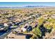 Expansive aerial view of a community featuring diverse housing and mountain views at 549 W Sweet Shrub Ave, Queen Creek, AZ 85140