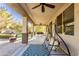A spacious covered patio with ceiling fans, swing chairs, and a view of the beautifully landscaped backyard at 549 W Sweet Shrub Ave, Queen Creek, AZ 85140