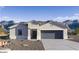 Charming single-story home featuring desert landscaping, a two-car garage and stylish architectural accents at 5771 E Axle Ln, San Tan Valley, AZ 85140
