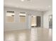 Sun-filled living room showcasing tile flooring, large windows, and sliding doors for seamless indoor-outdoor flow at 5771 E Axle Ln, San Tan Valley, AZ 85140