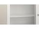 A close-up shot of an organized, empty white pantry with multiple shelves at 5771 E Axle Ln, San Tan Valley, AZ 85140