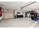 Spacious three car garage featuring epoxy floors, recessed lighting, and ample storage at 6526 W West Wind Dr, Glendale, AZ 85310