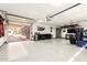 Bright three car garage featuring epoxy floors, recessed lighting, and an automatic door at 6526 W West Wind Dr, Glendale, AZ 85310
