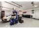 Automobile lift with vehicles stored in this spacious and well-equipped three car garage at 6526 W West Wind Dr, Glendale, AZ 85310
