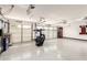 Three car garage features epoxy floors, recessed lighting, and multiple automatic doors at 6526 W West Wind Dr, Glendale, AZ 85310