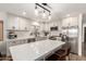 Modern kitchen boasts sleek white cabinets, stainless steel appliances, and a spacious center island at 6526 W West Wind Dr, Glendale, AZ 85310