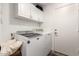 This practical laundry room features modern appliances and ample storage space, making chores a breeze at 6526 W West Wind Dr, Glendale, AZ 85310