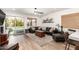 Cozy living room featuring a comfortable leather sofa, wood floors, and access to the backyard at 6526 W West Wind Dr, Glendale, AZ 85310
