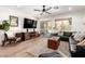 Bright living room featuring a comfortable leather sofa, wood floors, and backyard view at 6526 W West Wind Dr, Glendale, AZ 85310