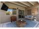 Cozy covered patio with a comfortable seating area and an outdoor television at 6526 W West Wind Dr, Glendale, AZ 85310