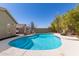 Backyard swimming pool features a waterslide, lush landscaping, and a fire pit at 6526 W West Wind Dr, Glendale, AZ 85310