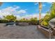 Backyard pool and hot tub featuring stone accents, lush landscaping and a view of the sunny sky at 6751 S Callaway Dr, Chandler, AZ 85249
