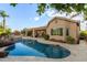 A serene backyard featuring a pool, outdoor kitchen, covered patio, and desert landscaping at 6751 S Callaway Dr, Chandler, AZ 85249