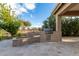Backyard featuring stone built-in BBQ, fire pit, desert landscaping and plenty of space for entertaining at 6751 S Callaway Dr, Chandler, AZ 85249