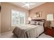 Cozy bedroom with neutral walls, plush carpeting, a ceiling fan, and plantation shutters at 6751 S Callaway Dr, Chandler, AZ 85249