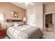 Bright bedroom with a comfortable queen-sized bed, carpeted floors, and neutral color palette at 6751 S Callaway Dr, Chandler, AZ 85249