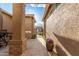 Outdoor courtyard with stone flooring, a gate, and desert landscaping at 6751 S Callaway Dr, Chandler, AZ 85249