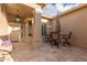 Private outdoor courtyard with stone flooring, seating, and an umbrella at 6751 S Callaway Dr, Chandler, AZ 85249