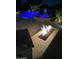 Outdoor fire pit and landscaped patio featuring pavers with a swimming pool and spa in the background at 6751 S Callaway Dr, Chandler, AZ 85249
