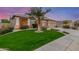 Well-maintained front yard features healthy green grass and a mature palm tree at 6751 S Callaway Dr, Chandler, AZ 85249