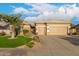 Charming home showcasing a lush front yard with a beautiful palm tree and manicured landscaping at 6751 S Callaway Dr, Chandler, AZ 85249