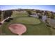 Aerial of green golf course with sand trap and lake, lined with mature trees at 6751 S Callaway Dr, Chandler, AZ 85249